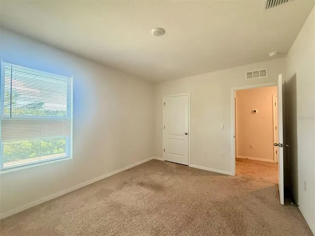 an empty room with a empty space and a window