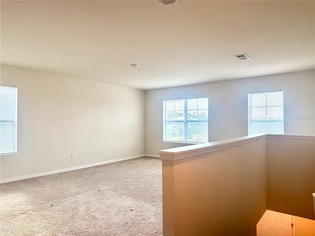 a living room with couches and a flat screen tv