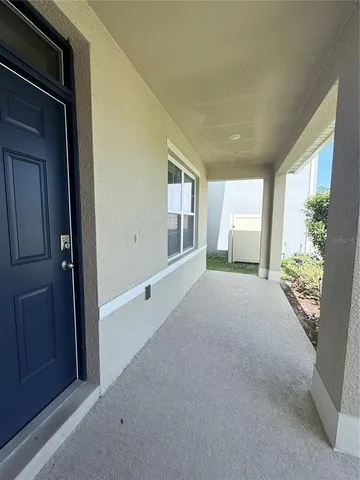 a view of empty room with large windows