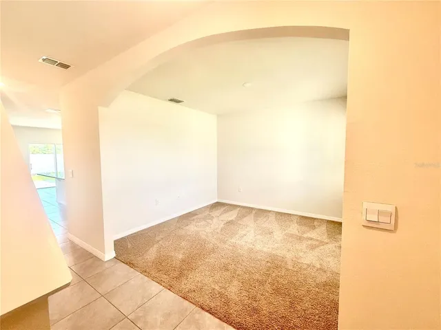 an empty room with a empty space and a window