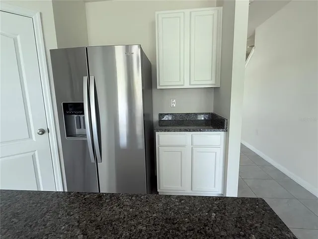 a kitchen with a sink a microwave and cabinets