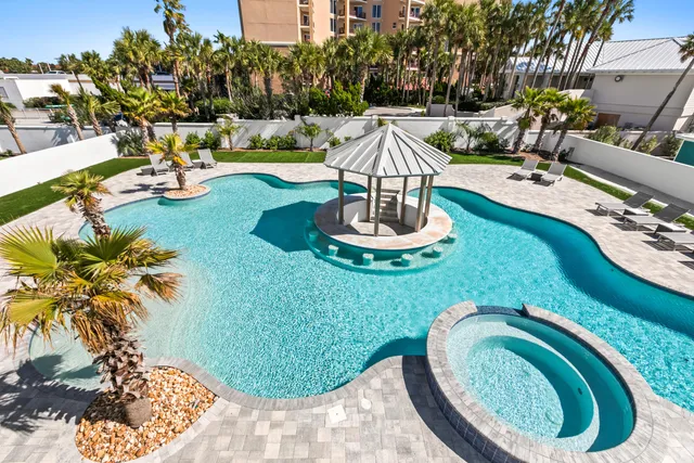 a living room with lots of furniture and view of kitchen