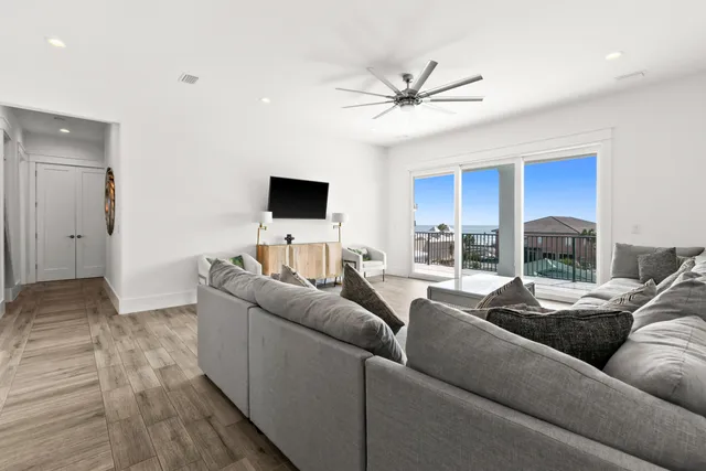 a living room with dining room and wooden floor