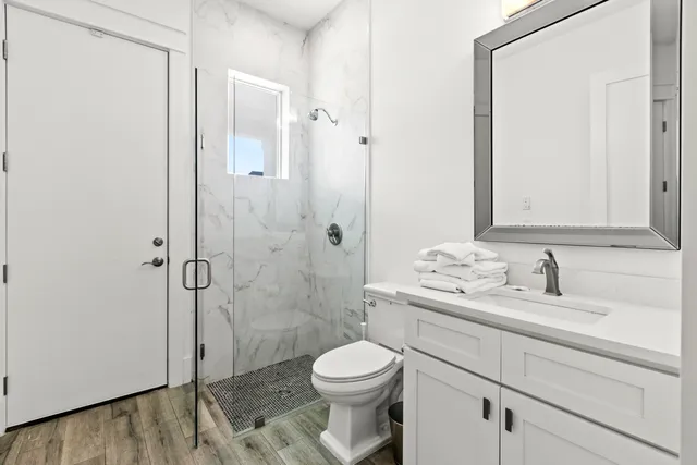 a view of a patio with couches table and chairs with plants and palm trees