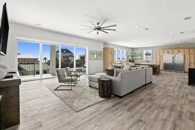 a living room with furniture a rug and a flat screen tv