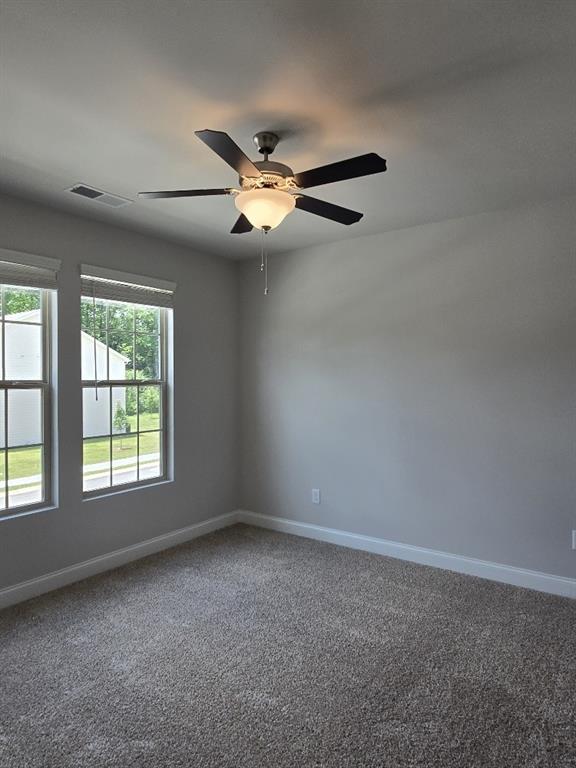6198 Ripple Way, Unit 87 Atlanta, GA 30349 - Photo 14 of 23 an empty room with windows and fan