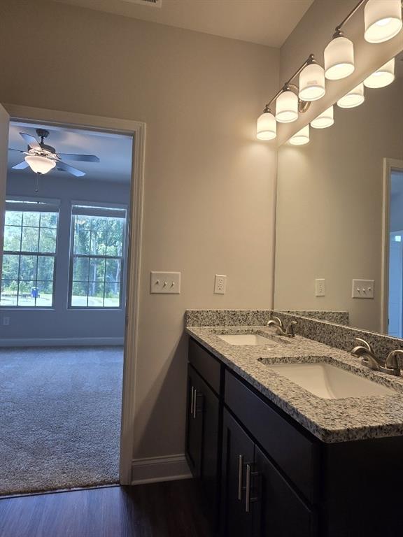 6198 Ripple Way, Unit 87 Atlanta, GA 30349 - Photo 16 of 23 a bathroom with a granite countertop sink and a mirror