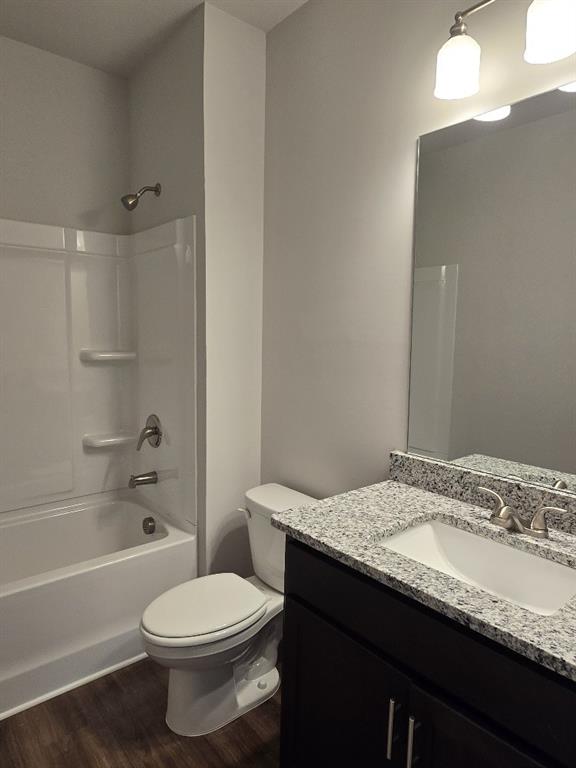 6198 Ripple Way, Unit 87 Atlanta, GA 30349 - Photo 21 of 23 a bathroom with a granite countertop bathtub sink vanity mirror and toilet