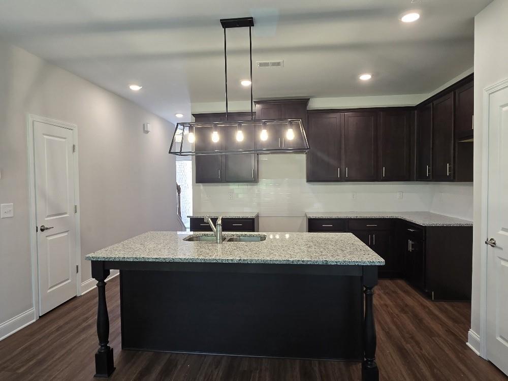 6198 Ripple Way, Unit 87 Atlanta, GA 30349 - Photo 3 of 23 a kitchen with a sink cabinets and wooden floor