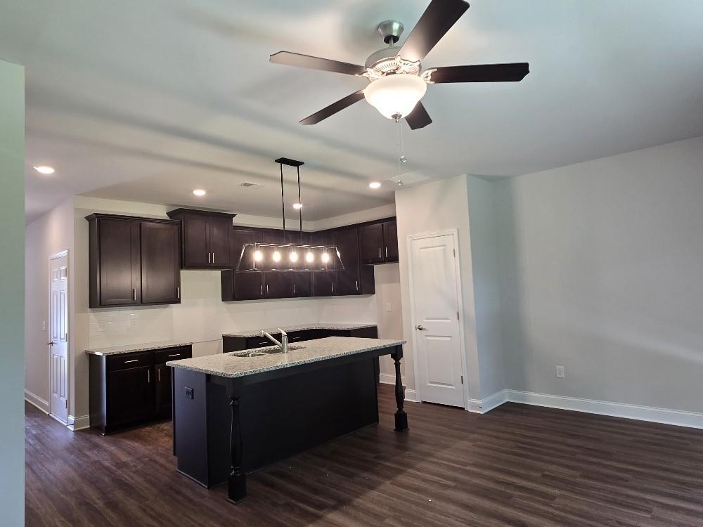 6198 Ripple Way, Unit 87 Atlanta, GA 30349 - Photo 4 of 23 a kitchen with stainless steel appliances a refrigerator and a stove top oven