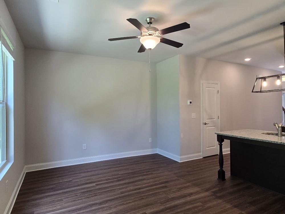 6198 Ripple Way, Unit 87 Atlanta, GA 30349 - Photo 9 of 23 a view of an empty room with wooden floor and a window