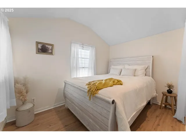 a bedroom with a bed and a potted plant