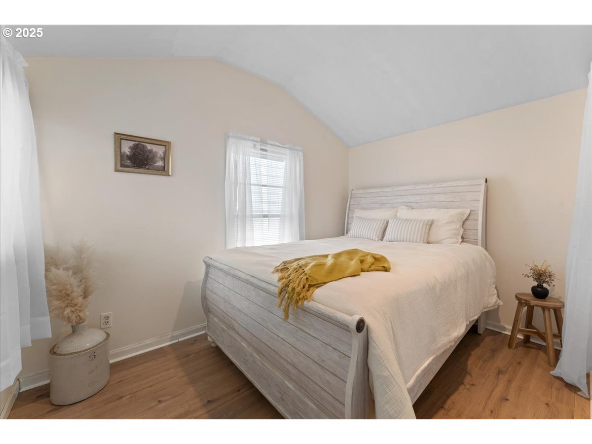 830 Oceanway Street Seaside, OR 97138 - Photo 12 of 35 a bedroom with a bed and a potted plant