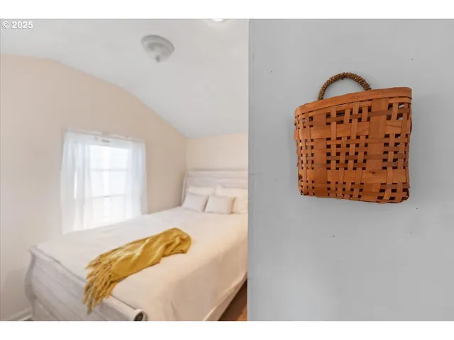 a bedroom with a bed with a white comforter and pillows