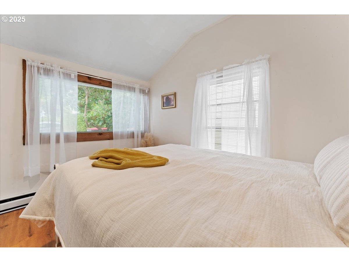 830 Oceanway Street Seaside, OR 97138 - Photo 14 of 35 a bedroom with a bed and a large window