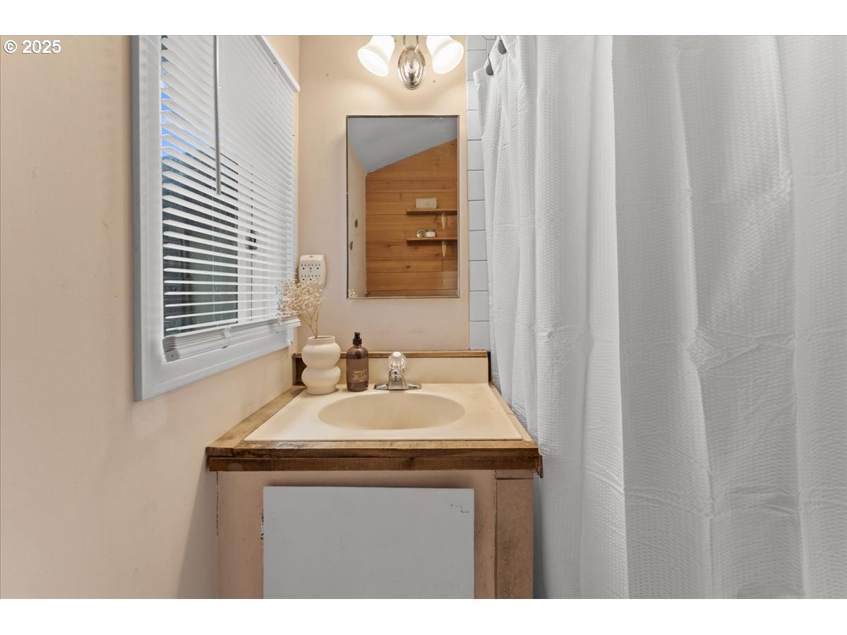 830 Oceanway Street Seaside, OR 97138 - Photo 16 of 35 a bathroom with a sink and a mirror