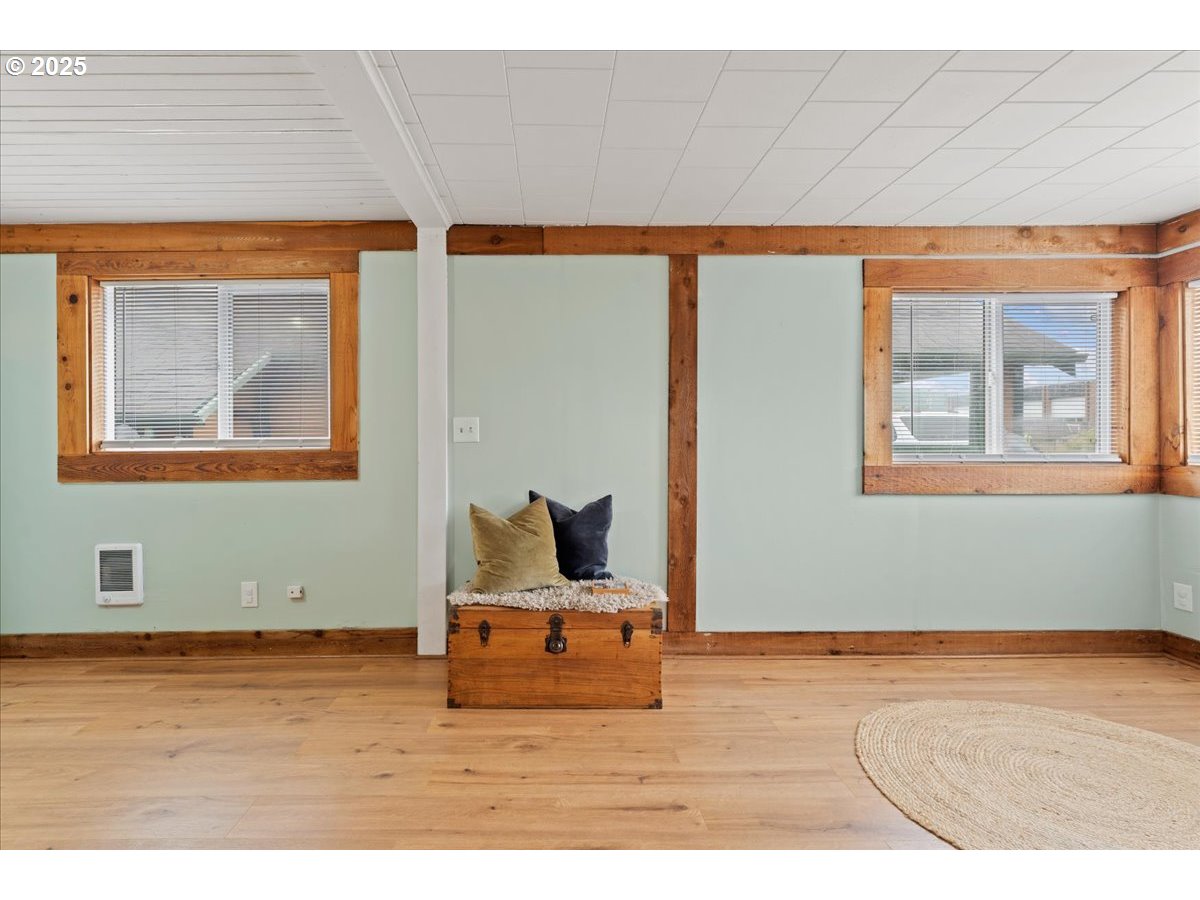830 Oceanway Street Seaside, OR 97138 - Photo 6 of 35 a room with wooden floor and windows