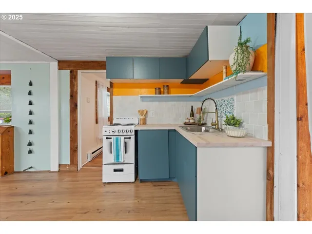 a kitchen that has a sink and a wooden floor
