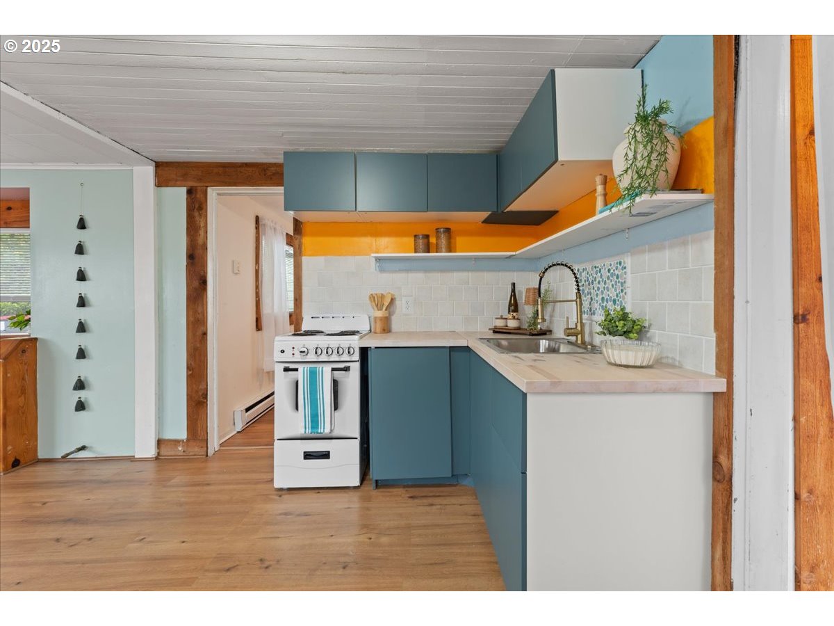 830 Oceanway Street Seaside, OR 97138 - Photo 8 of 35 a kitchen that has a sink and a wooden floor