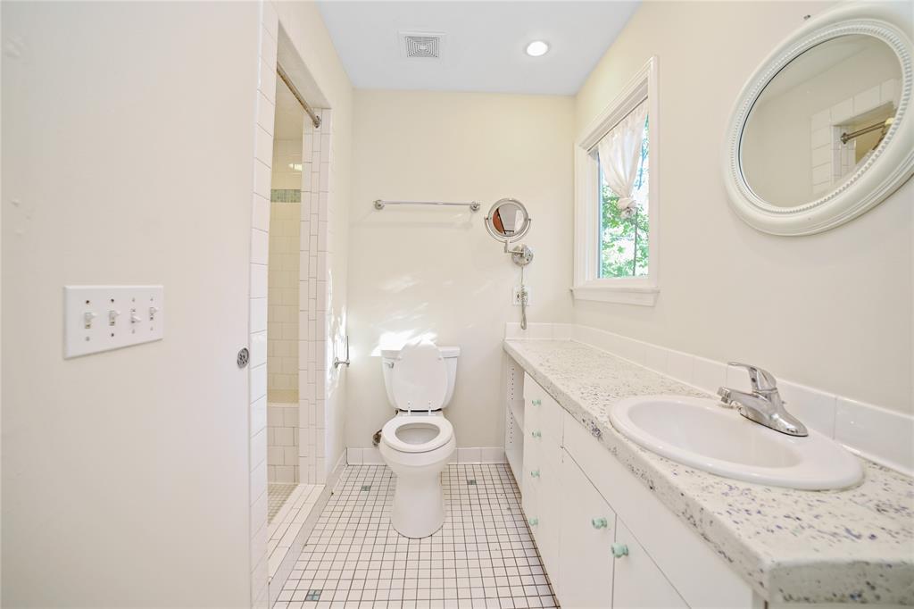 2716 East 22nd Street, Unit A Austin, TX 78722 - Photo 4 of 11 a bathroom with a sink a toilet and a mirror