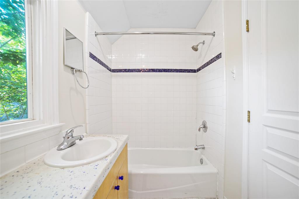 2716 East 22nd Street, Unit A Austin, TX 78722 - Photo 7 of 11 a bathroom with a tub a sink and a window