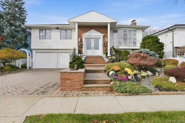 a front view of a house with a garden