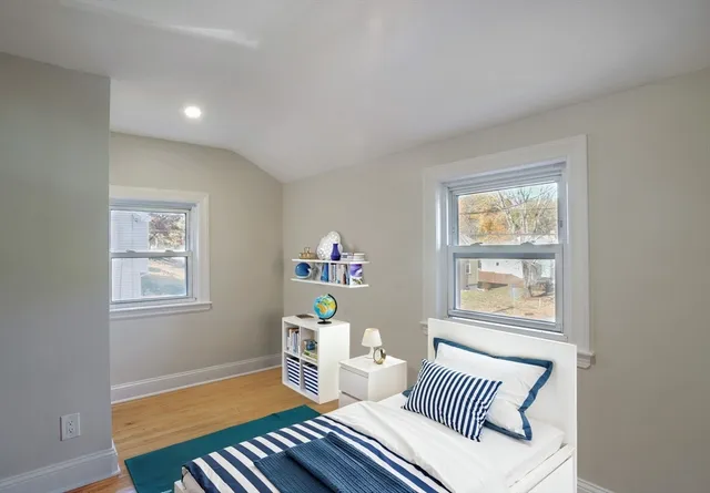 a bedroom with furniture and a window