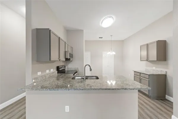 a kitchen with a sink and a mirror