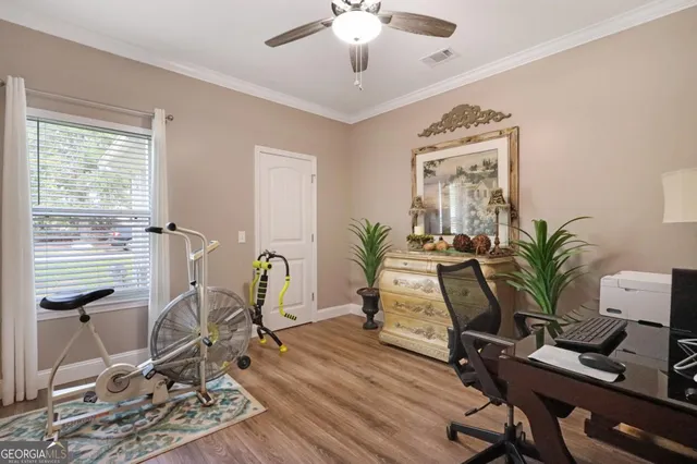 a view of a workspace with furniture and a potted plant