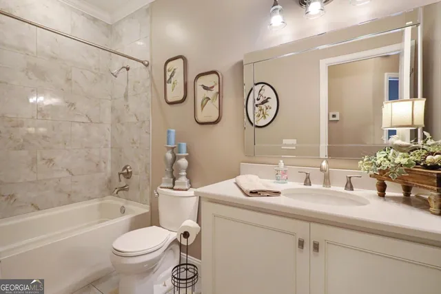 a bathroom with a sink mirror toilet and bathtub