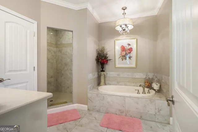 a bath tub sitting next to a bathroom sink and a shower