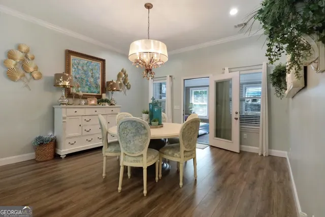 a view of a dining room with furniture wooden floor and chandelier