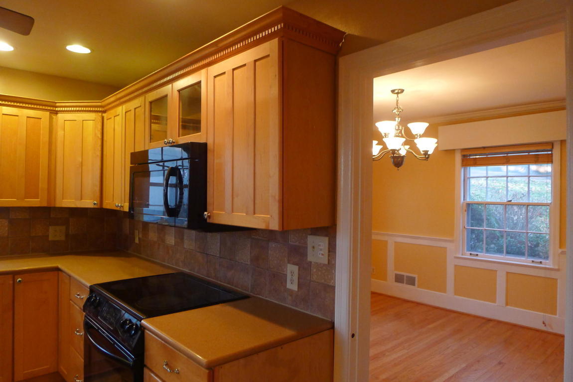 3125 Stoneridge Road Southwest Roanoke, VA 24014 - Photo 5 of 28 a kitchen with granite countertop cabinets and wooden floor