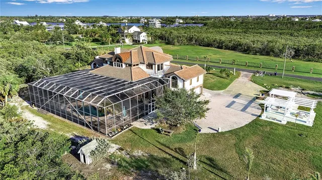 a view of a garden with a car park in front of the house