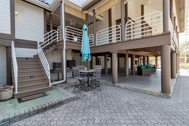 a view of a patio with a table and chairs under an umbrella
