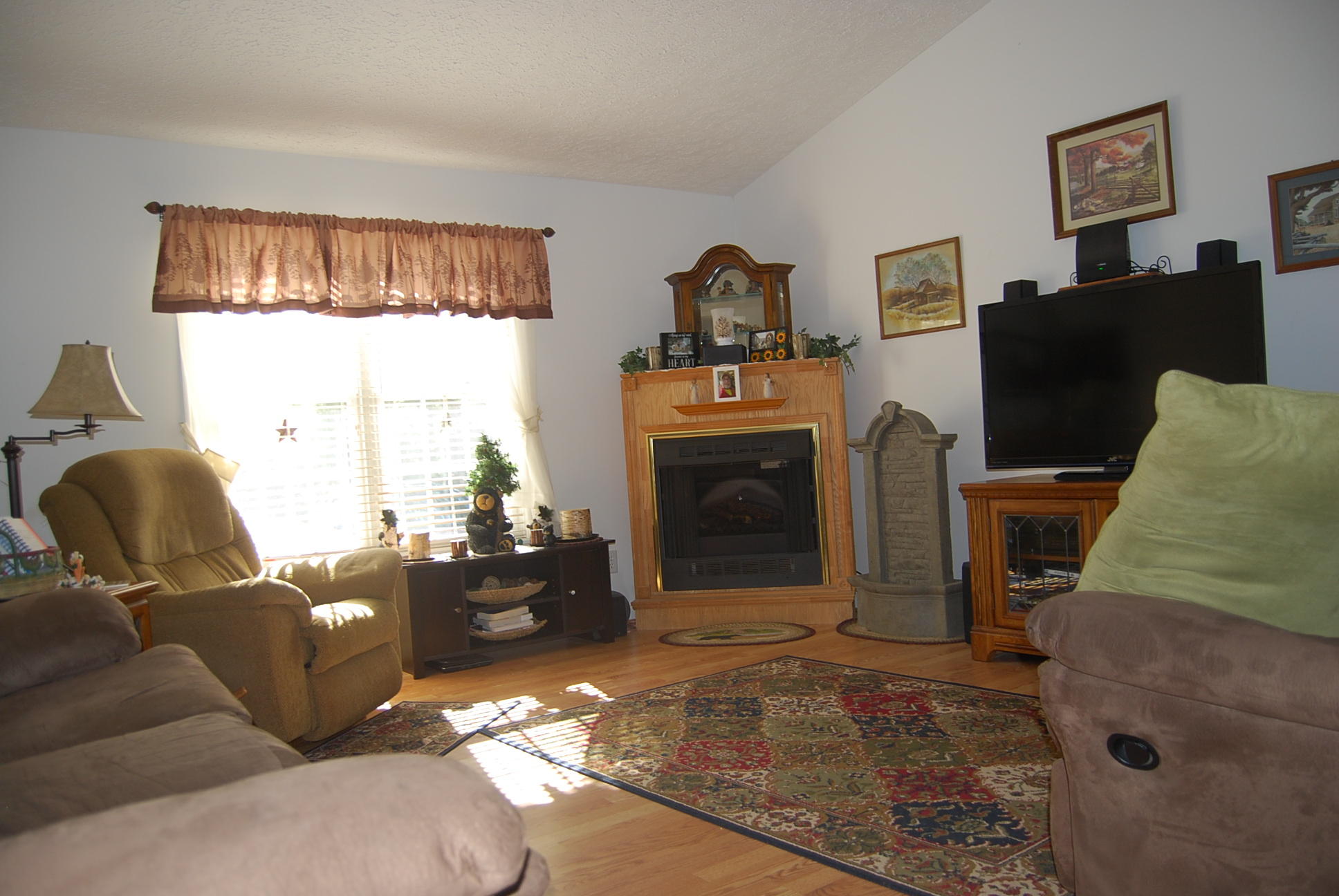 736 Holland Road Callaway, VA 24067 - Photo 6 of 45 a living room with furniture a flat screen tv and a fireplace