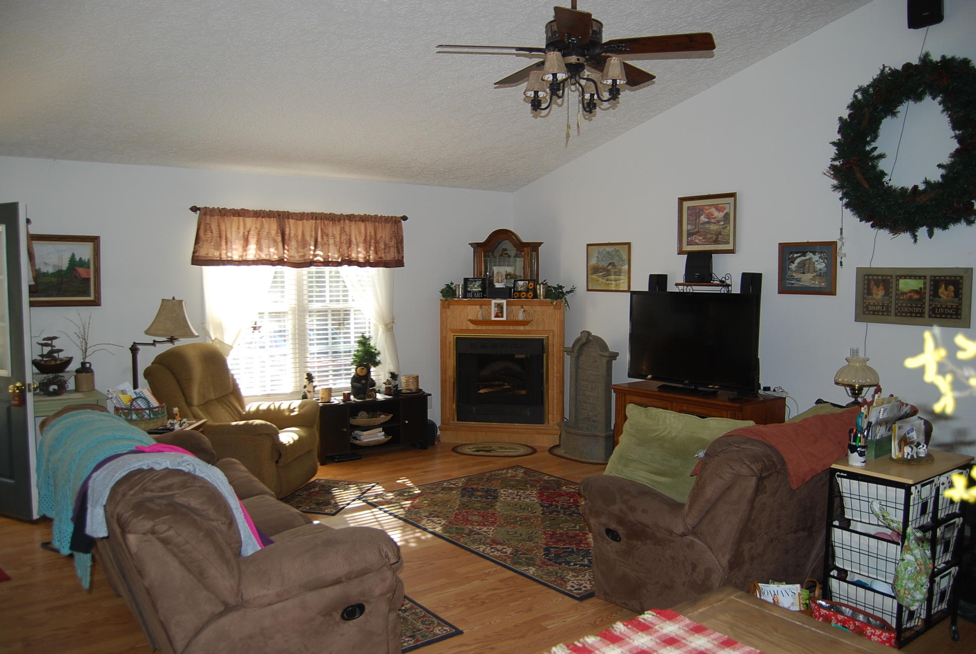 736 Holland Road Callaway, VA 24067 - Photo 7 of 45 a living room with furniture a fireplace and a flat screen tv