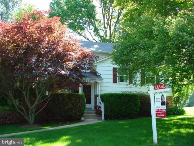 2001 Mcfall Street McLean, VA 22101 - Photo 3 of 4 a view of a white house with a big yard and a large tree