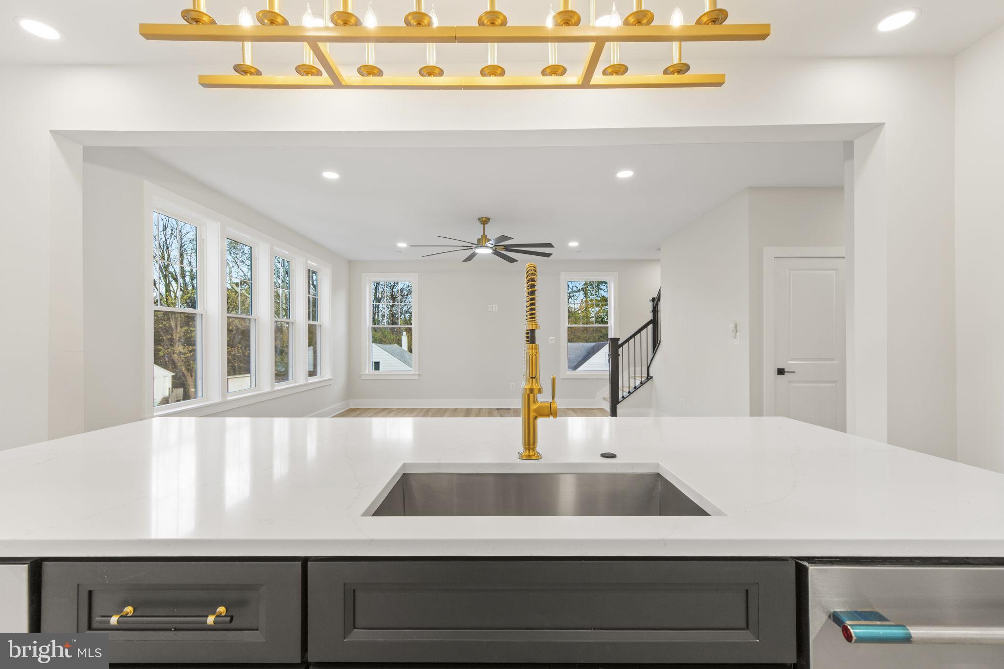 1108 Litchfield Road Baltimore, MD 21239 - Photo 11 of 109 a view of a kitchen with kitchen island a sink and wooden floor