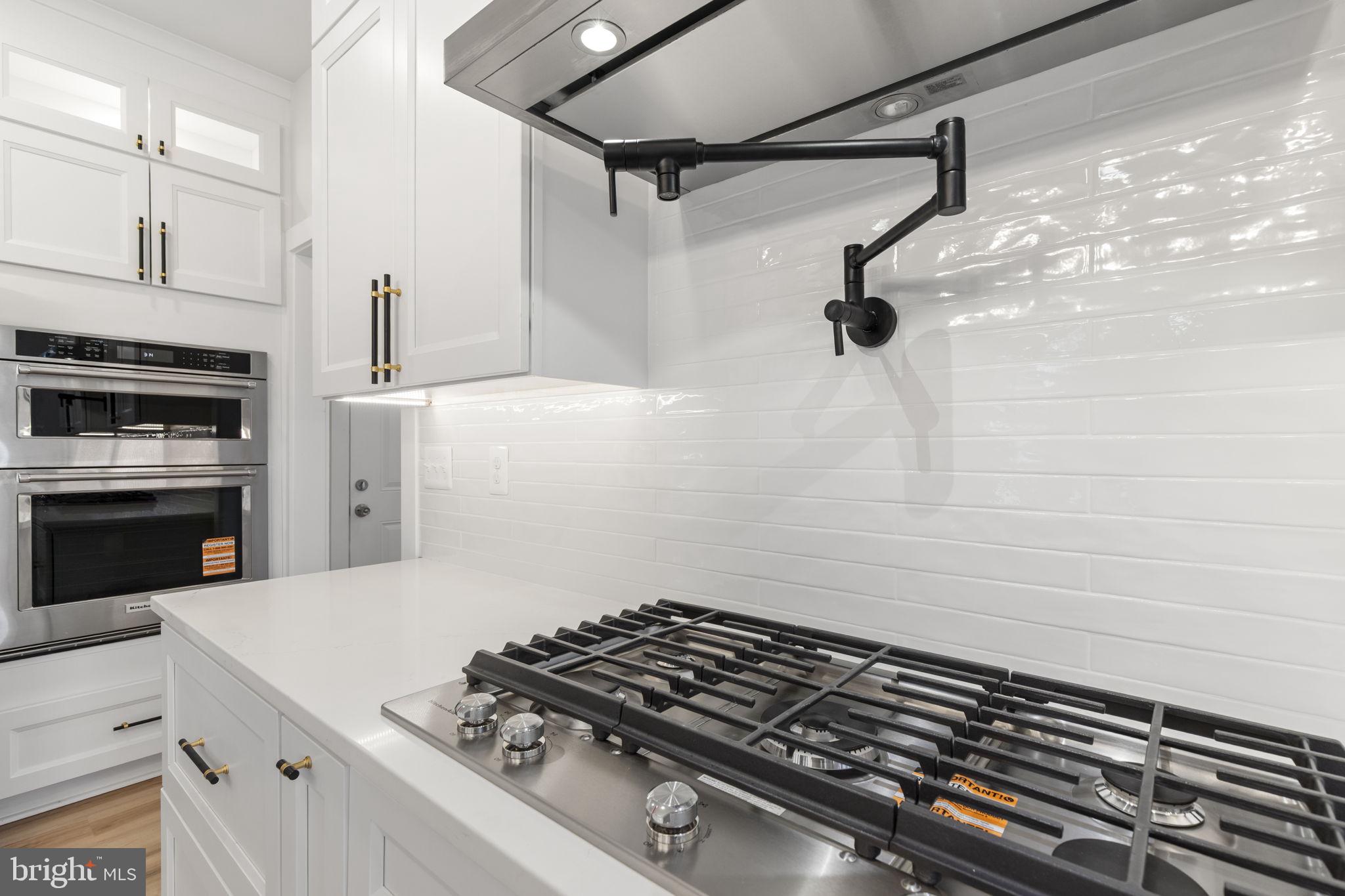 1108 Litchfield Road Baltimore, MD 21239 - Photo 13 of 109 a kitchen with a stove and a refrigerator