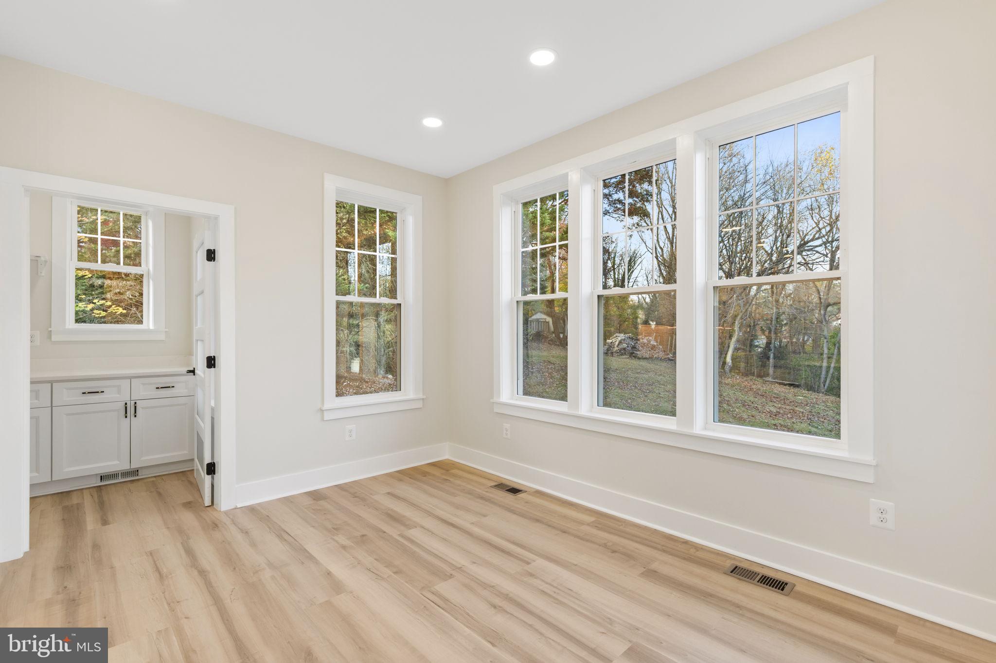 1108 Litchfield Road Baltimore, MD 21239 - Photo 14 of 109 a view of an empty room with a window and wooden floor