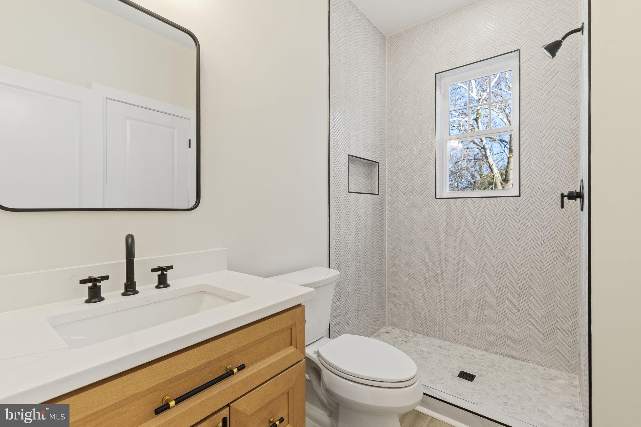 1108 Litchfield Road Baltimore, MD 21239 - Photo 18 of 109 a bathroom with a sink a toilet and shower