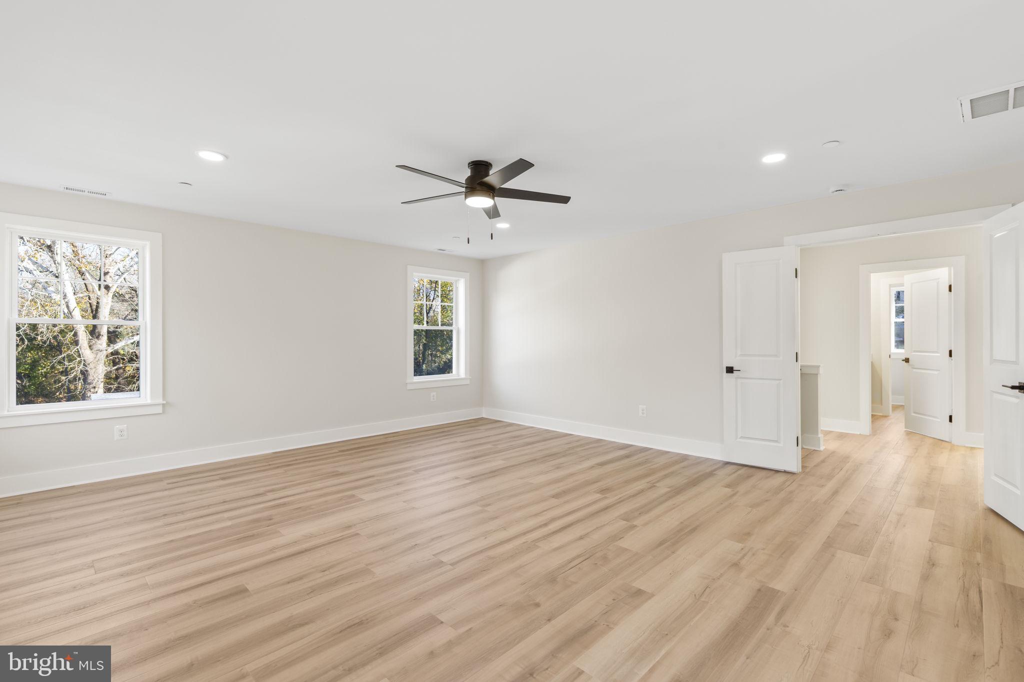 1108 Litchfield Road Baltimore, MD 21239 - Photo 19 of 109 an empty room with wooden floor and windows