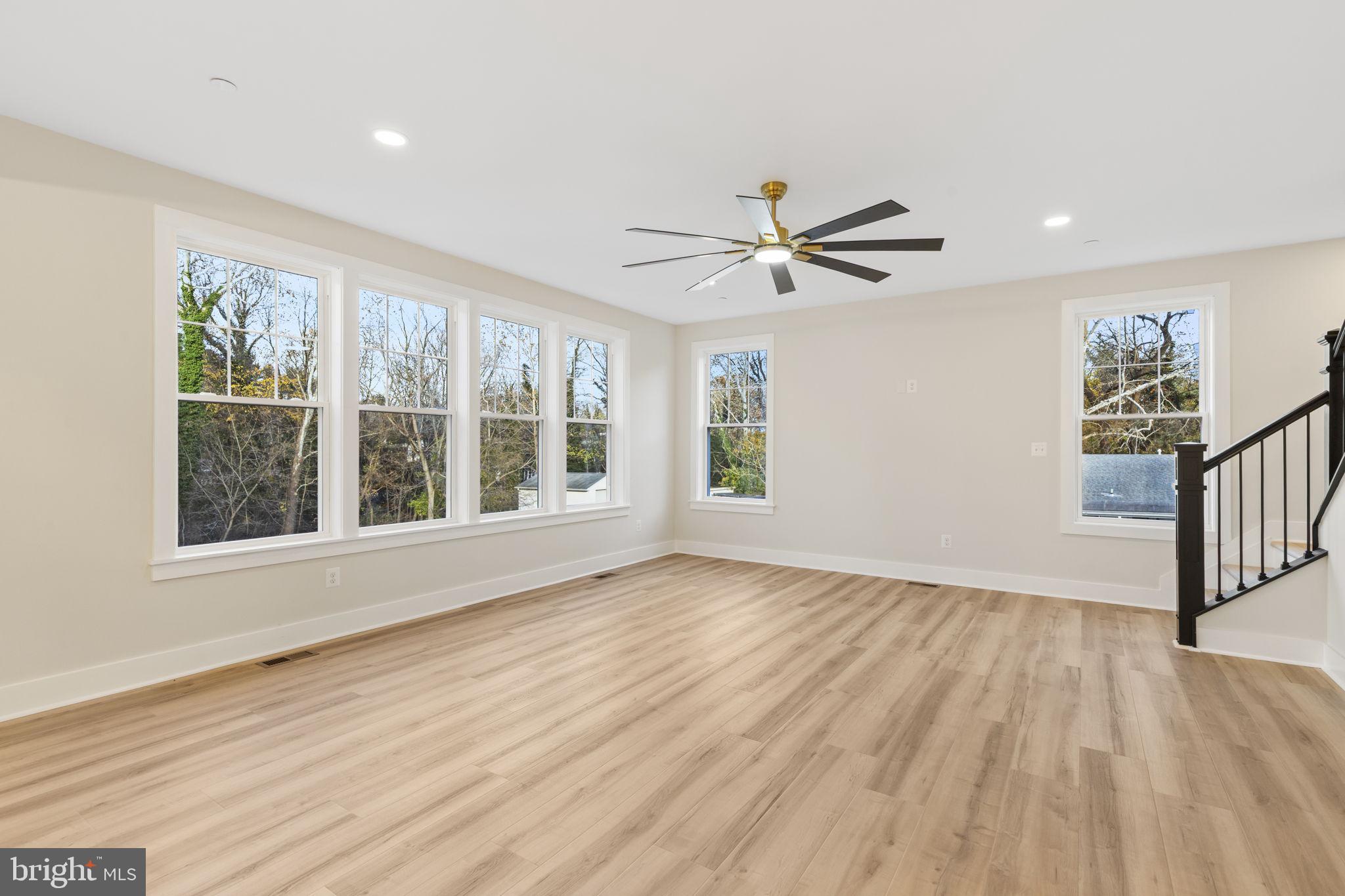 1108 Litchfield Road Baltimore, MD 21239 - Photo 2 of 109 a view of an empty room with a window and wooden floor