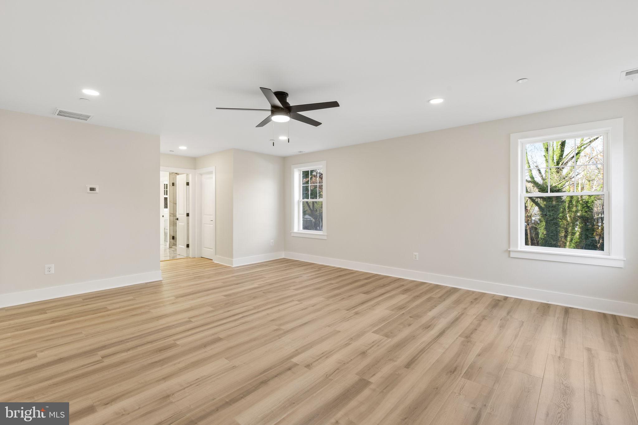 1108 Litchfield Road Baltimore, MD 21239 - Photo 21 of 109 a view of empty room with wooden floor and fan