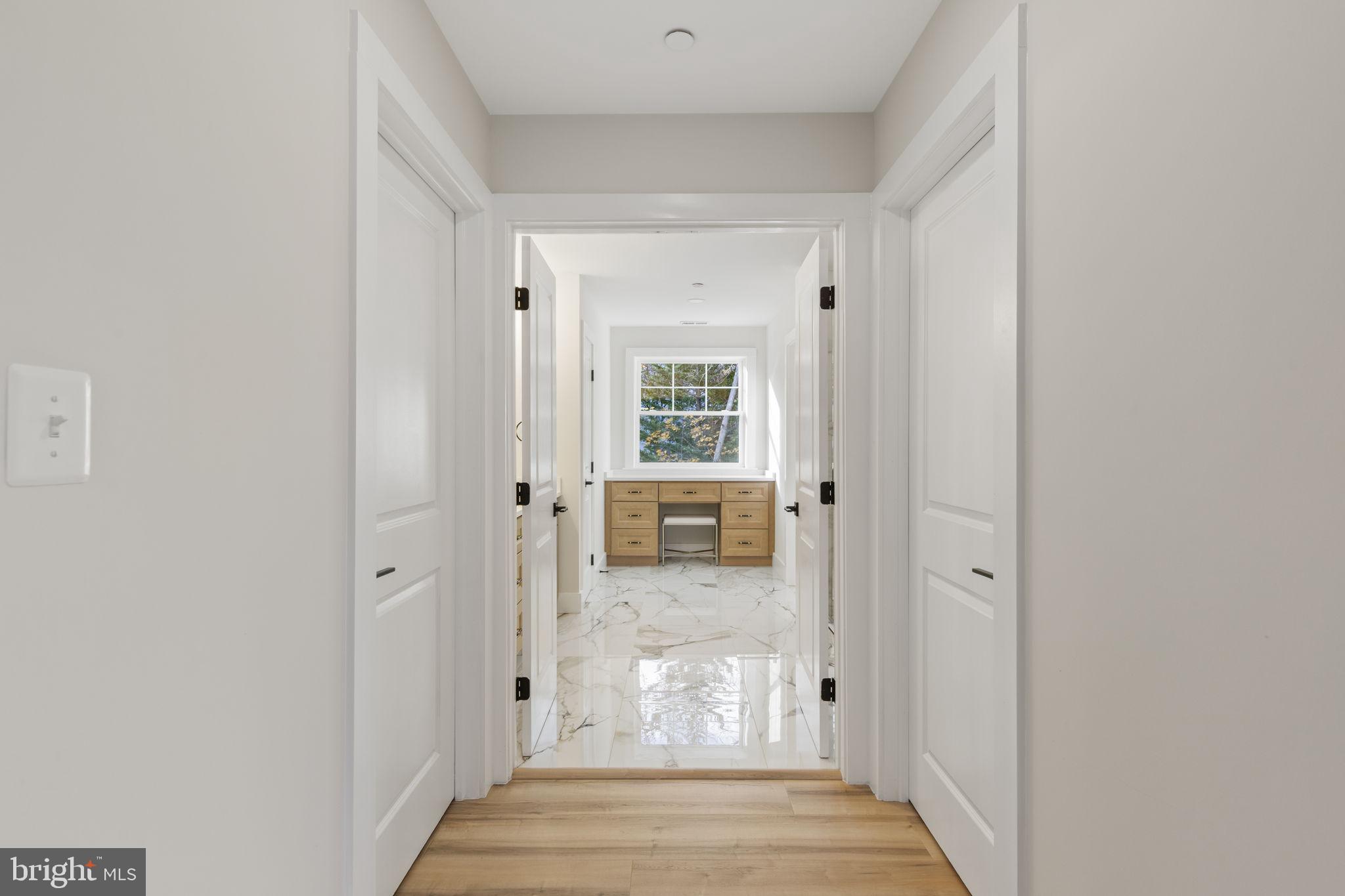 1108 Litchfield Road Baltimore, MD 21239 - Photo 22 of 109 a view of a hallway with wooden floor and a living room