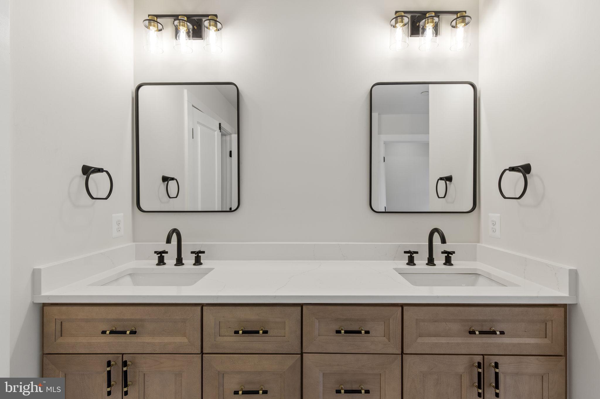 1108 Litchfield Road Baltimore, MD 21239 - Photo 25 of 109 a bathroom with double vanity sinks and a mirror