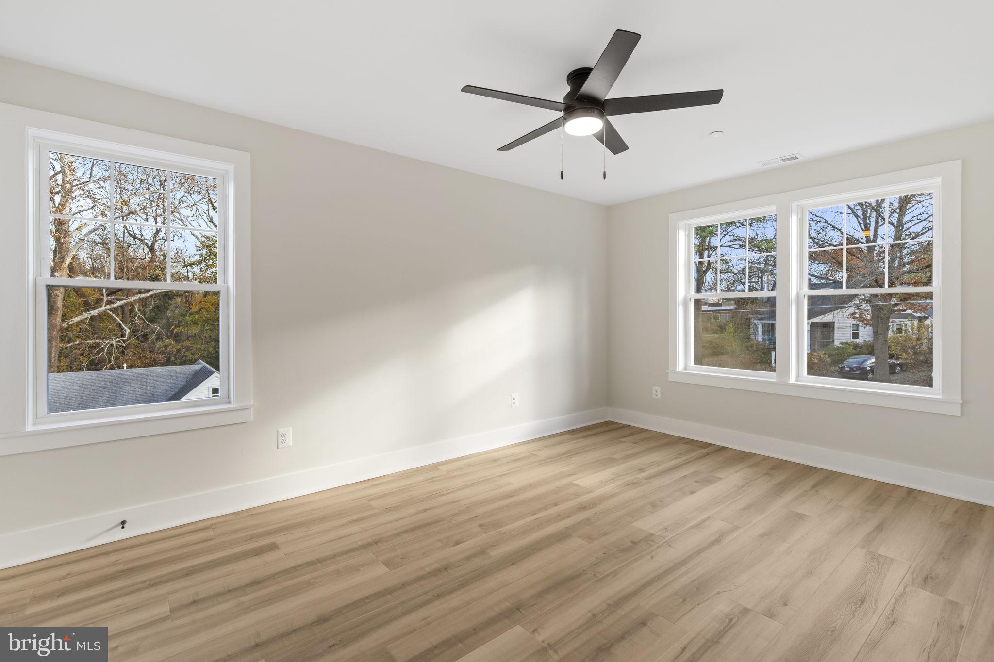 1108 Litchfield Road Baltimore, MD 21239 - Photo 31 of 109 a view of a big room with wooden floor and windows