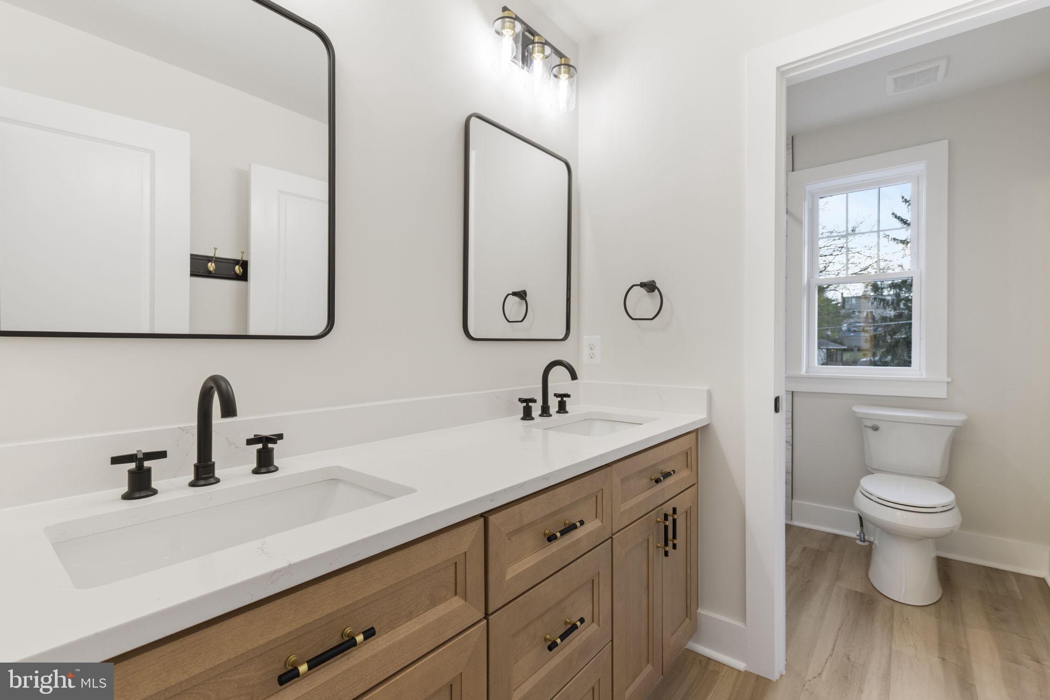 1108 Litchfield Road Baltimore, MD 21239 - Photo 37 of 109 a bathroom with a double vanity sink and a mirror