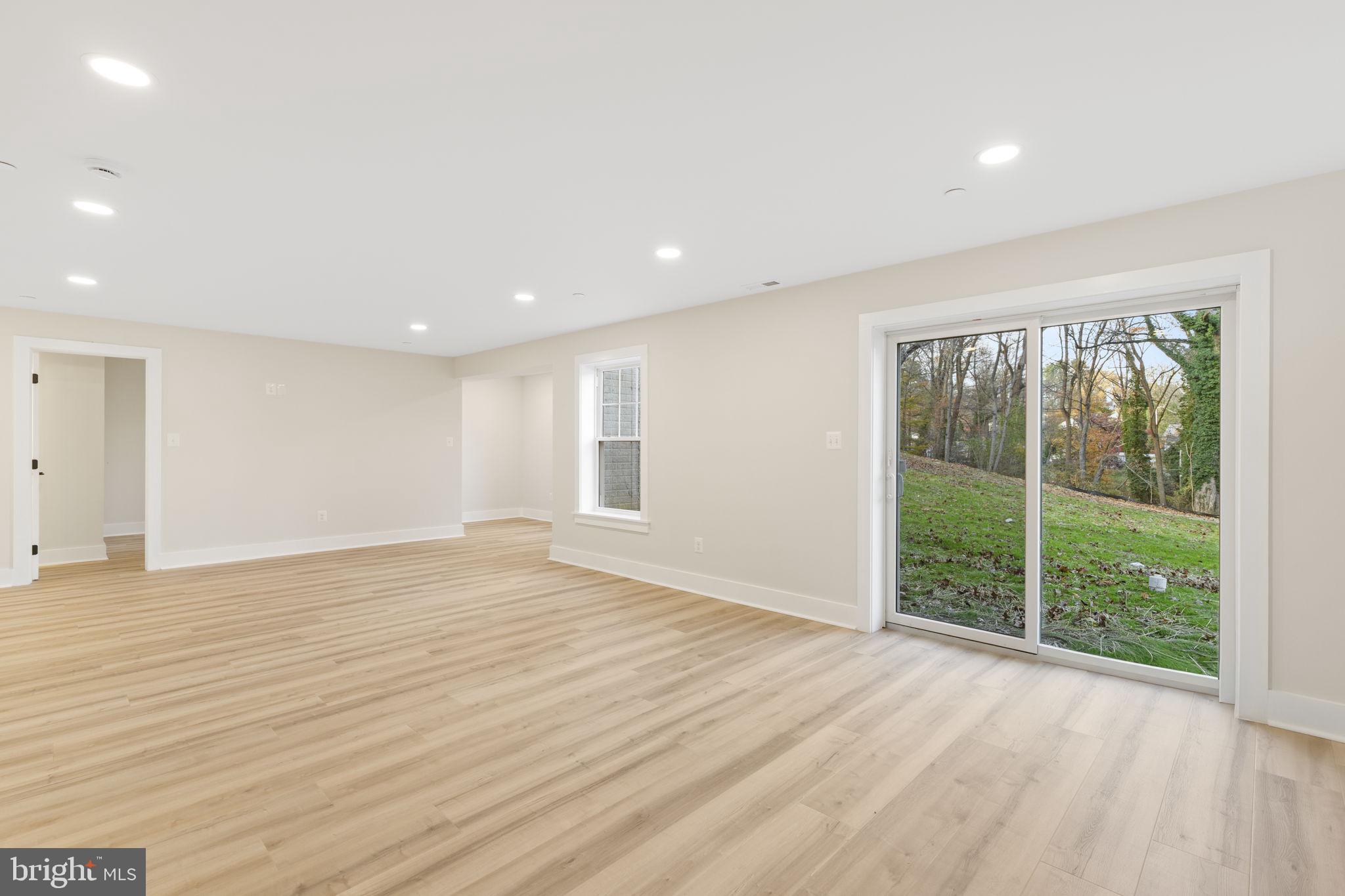 1108 Litchfield Road Baltimore, MD 21239 - Photo 39 of 109 a view of an empty room with wooden floor and a window